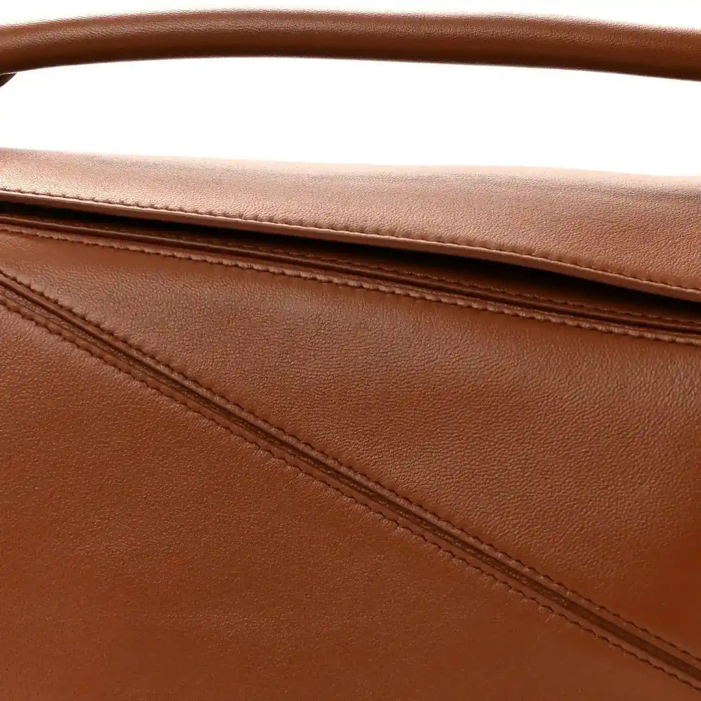 Pecan brown leather bag panel with stitched seam detail and top edge
