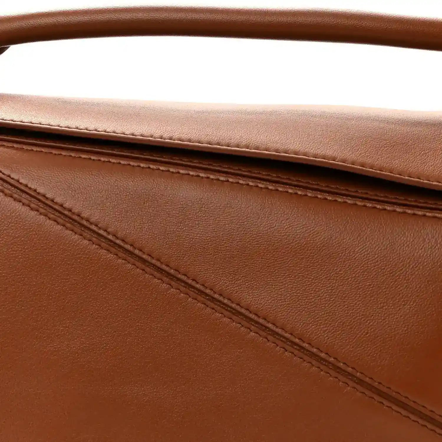 Pecan brown leather bag panel with stitched seam detail and top edge