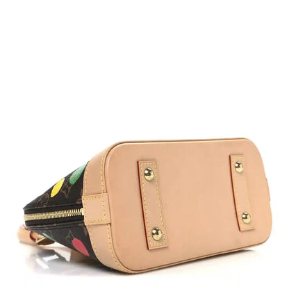 Small handbag with tan front panel, gold-tone hardware, dot-print side.