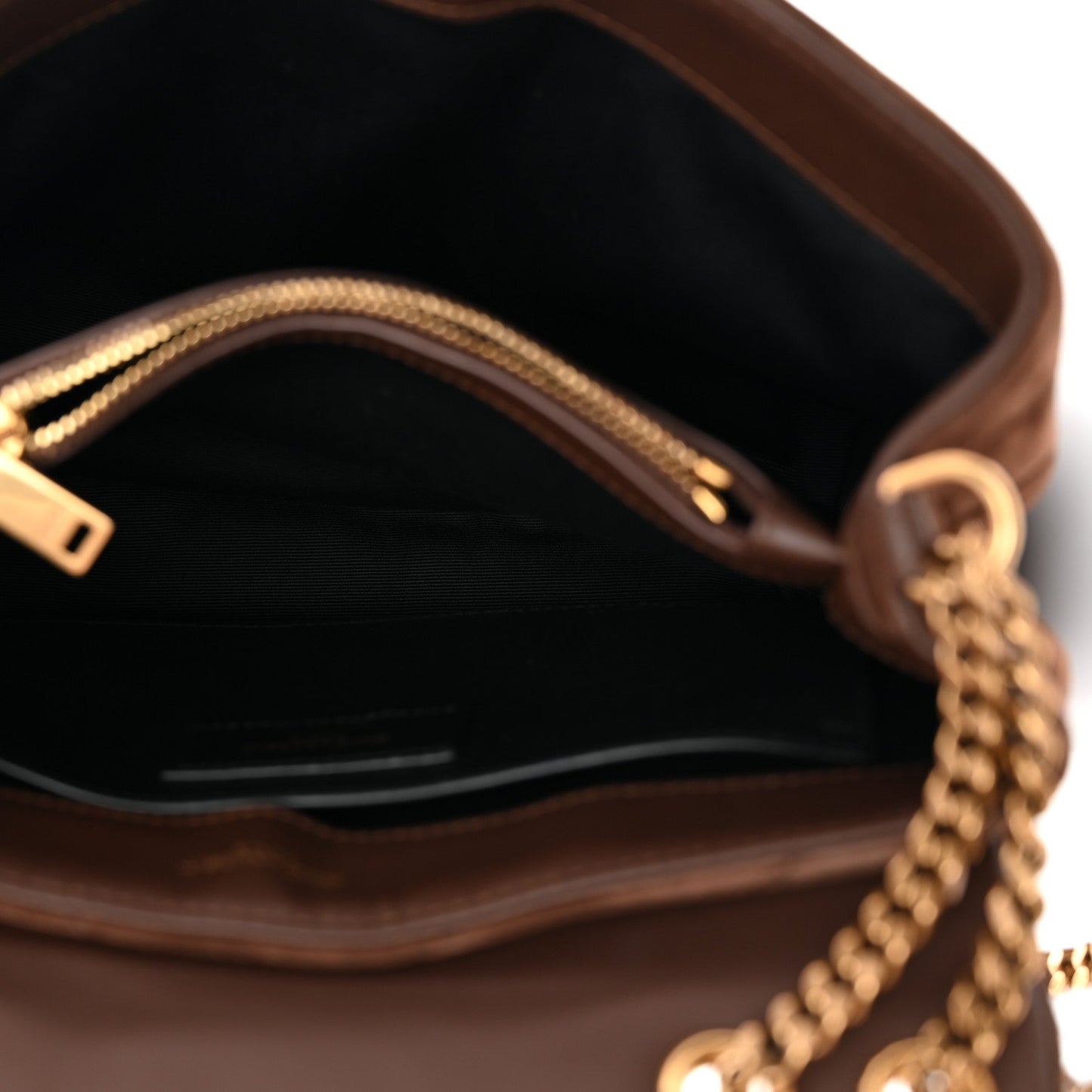 Suede satchel interior with chain strap hardware and visible zipper top