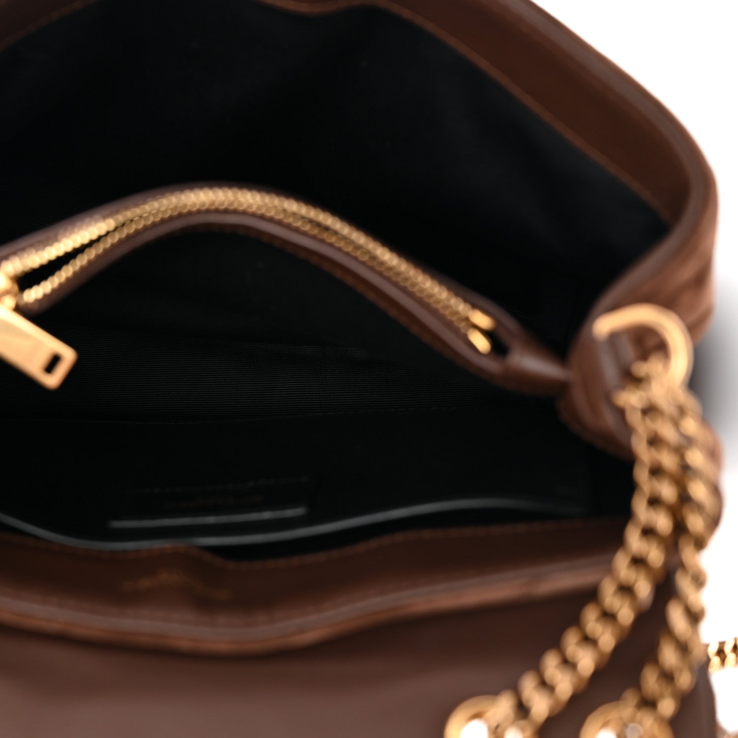 Suede satchel interior with chain strap hardware and visible zipper top