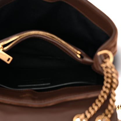 Suede satchel interior with chain strap hardware and visible zipper top