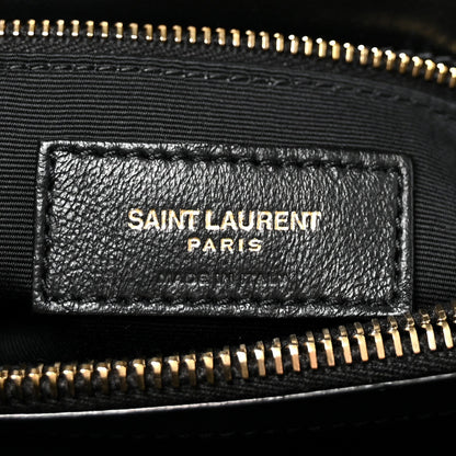 Black leather logo patch with SAINT LAURENT PARIS text and gold zipper