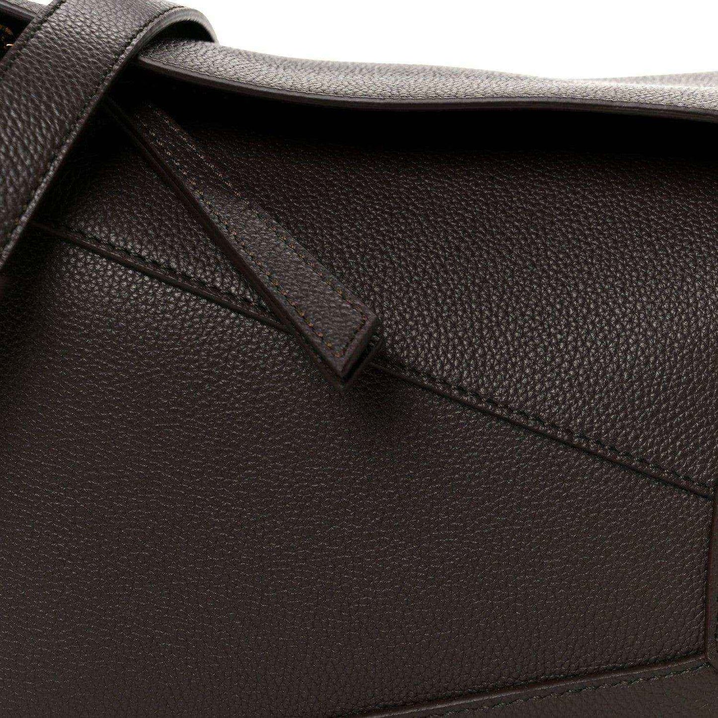 Dark chestnut grained leather strap attachment and diagonal panel seam detail