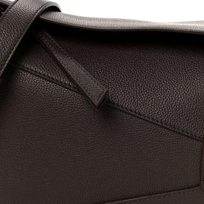 Dark chestnut grained leather strap attachment and diagonal panel seam detail