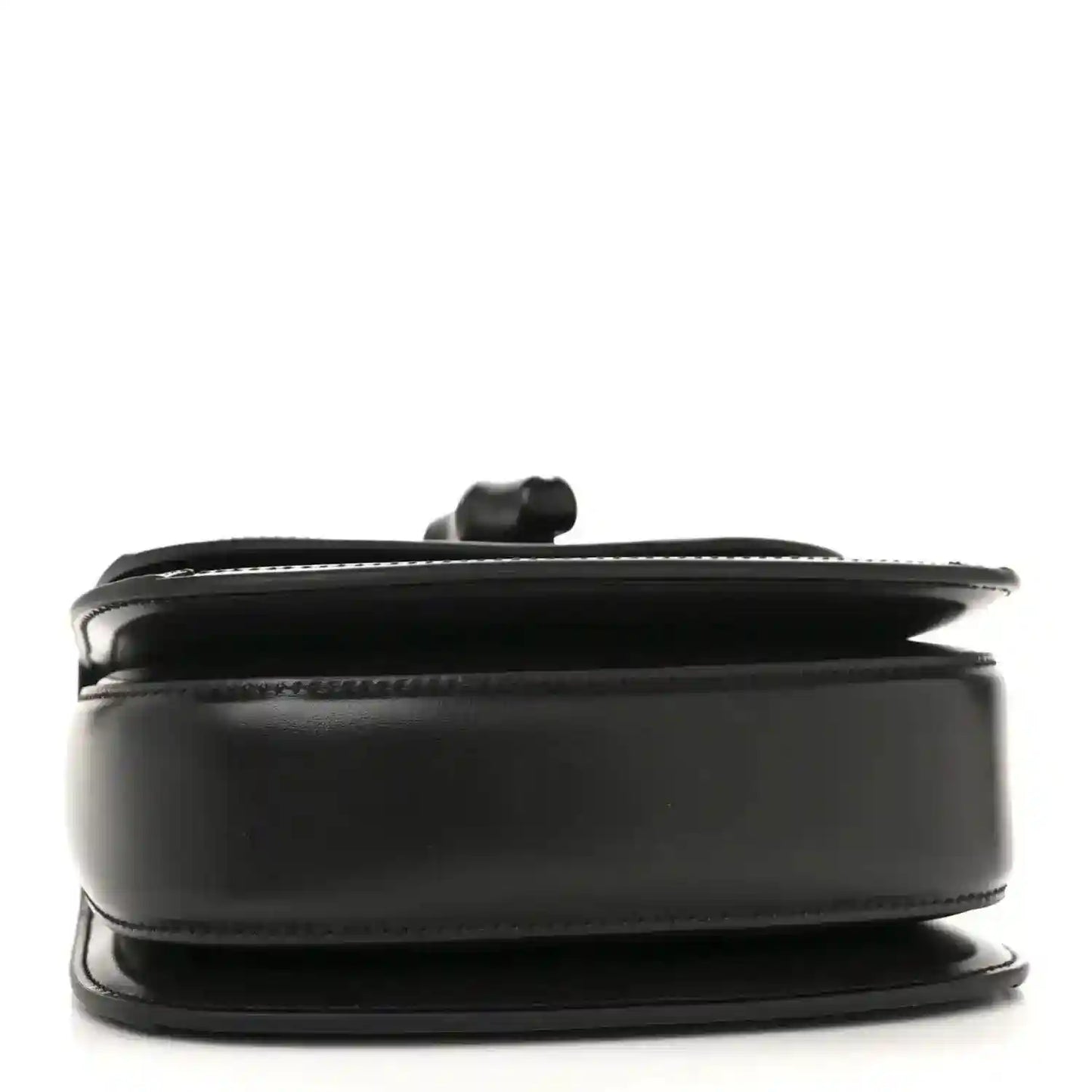 Black mini handbag side profile with curved top handle and smooth trim.