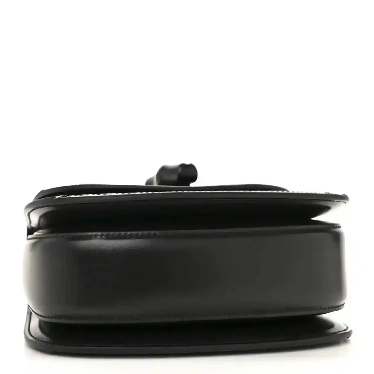 Black mini handbag side profile with curved top handle and smooth trim.