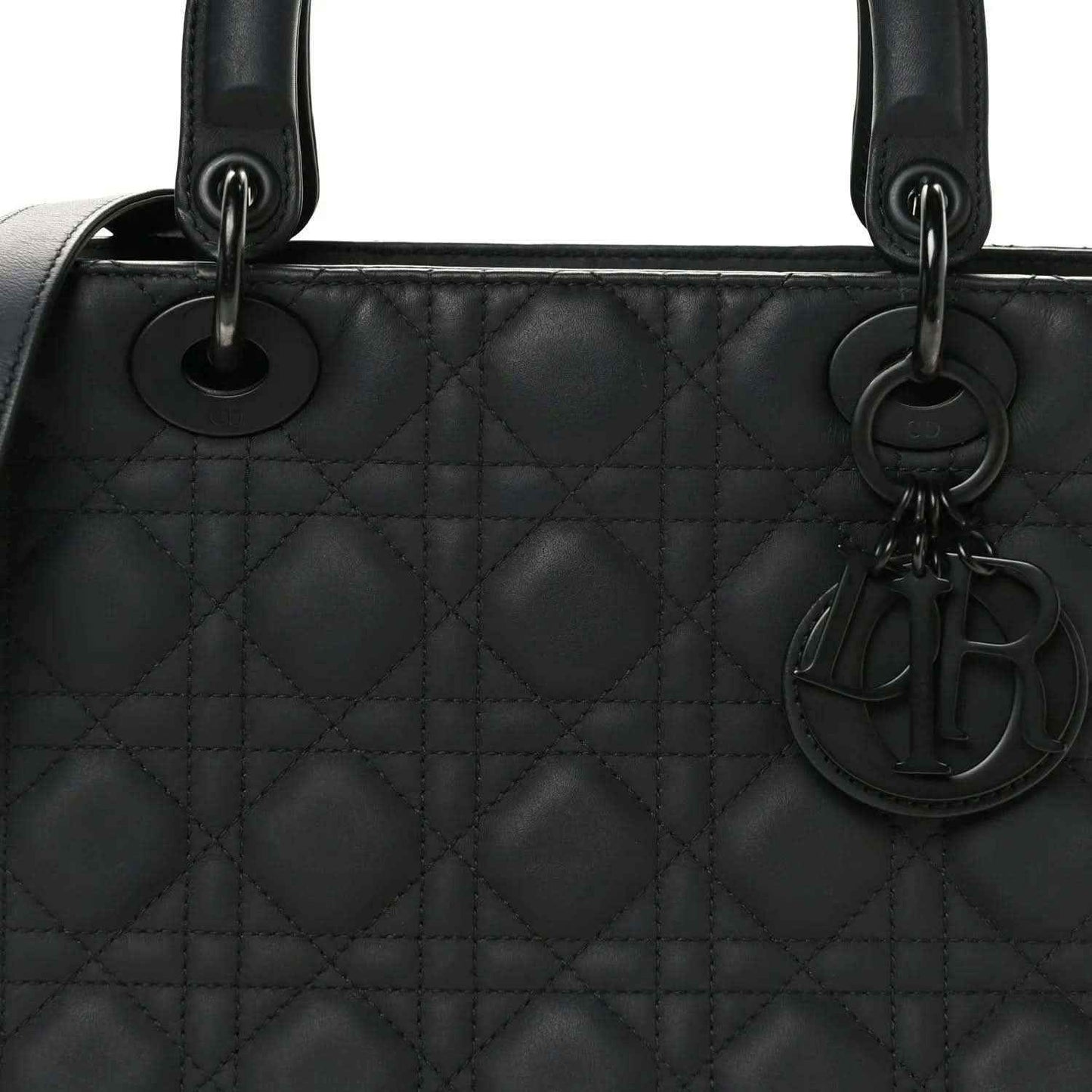 Black quilted Lady Dior bag with top handles, rings, and hanging charm