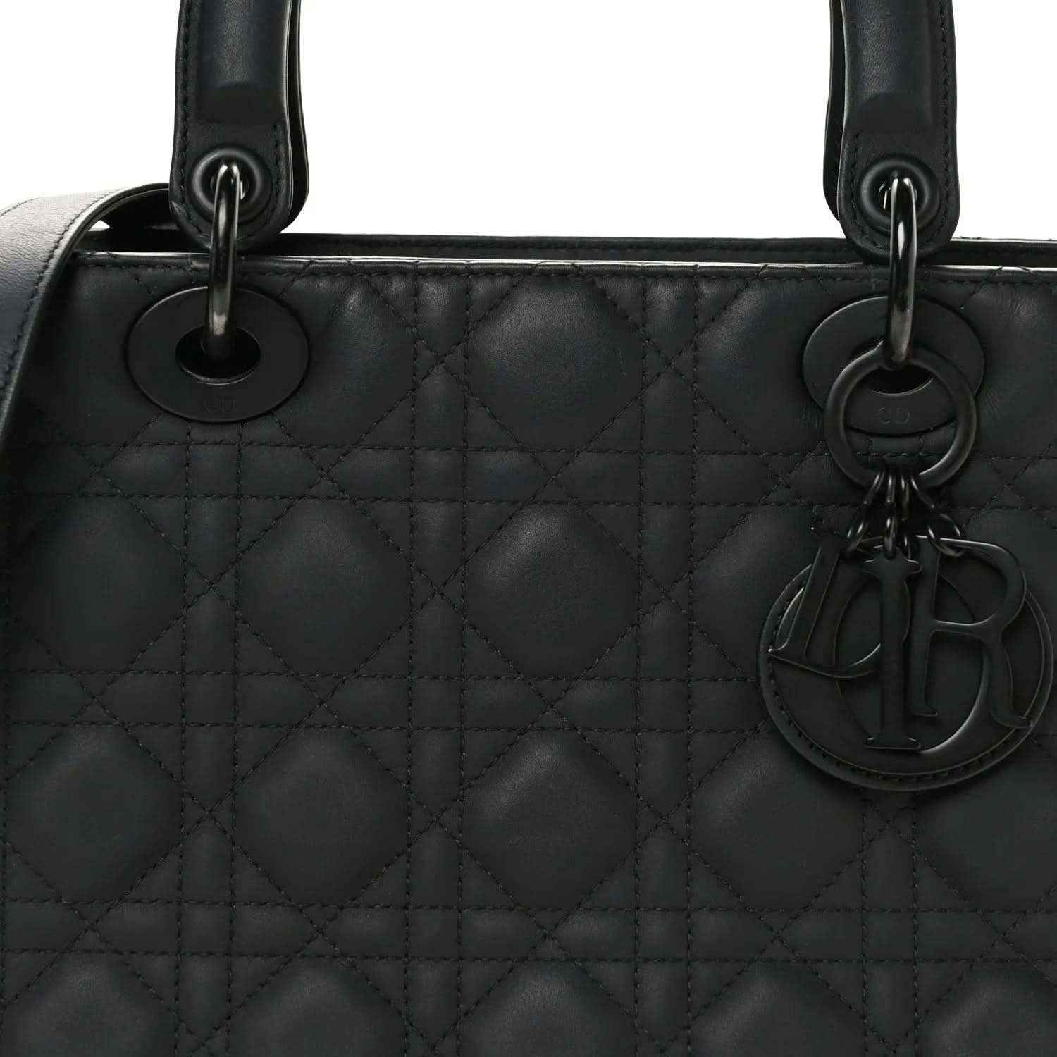 Black quilted Lady Dior bag with top handles, rings, and hanging charm