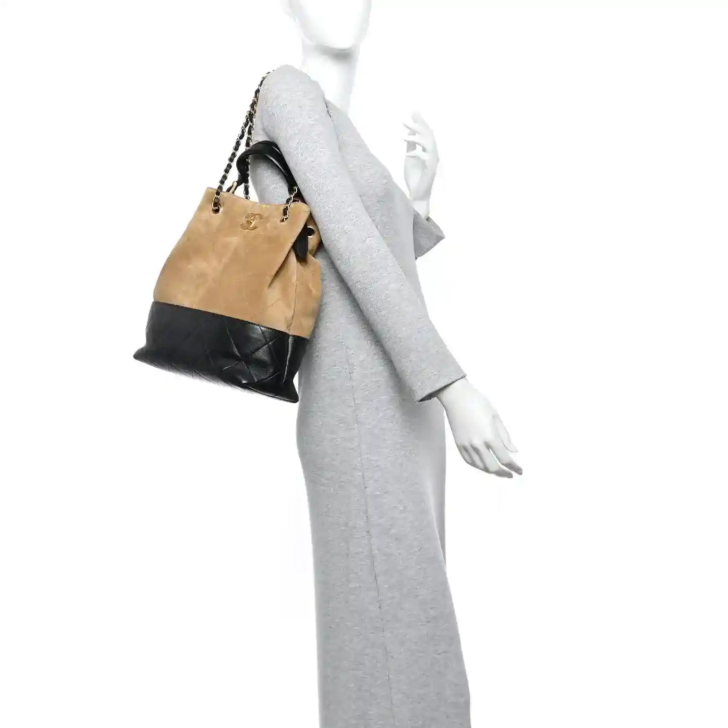 Chanel quilted suede shopping bag with beige body and black bottom, held on shoulder