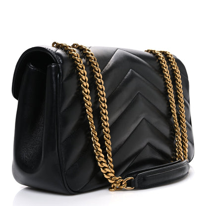 Black chevron-quilted shoulder bag with gold chain strap, side detail view