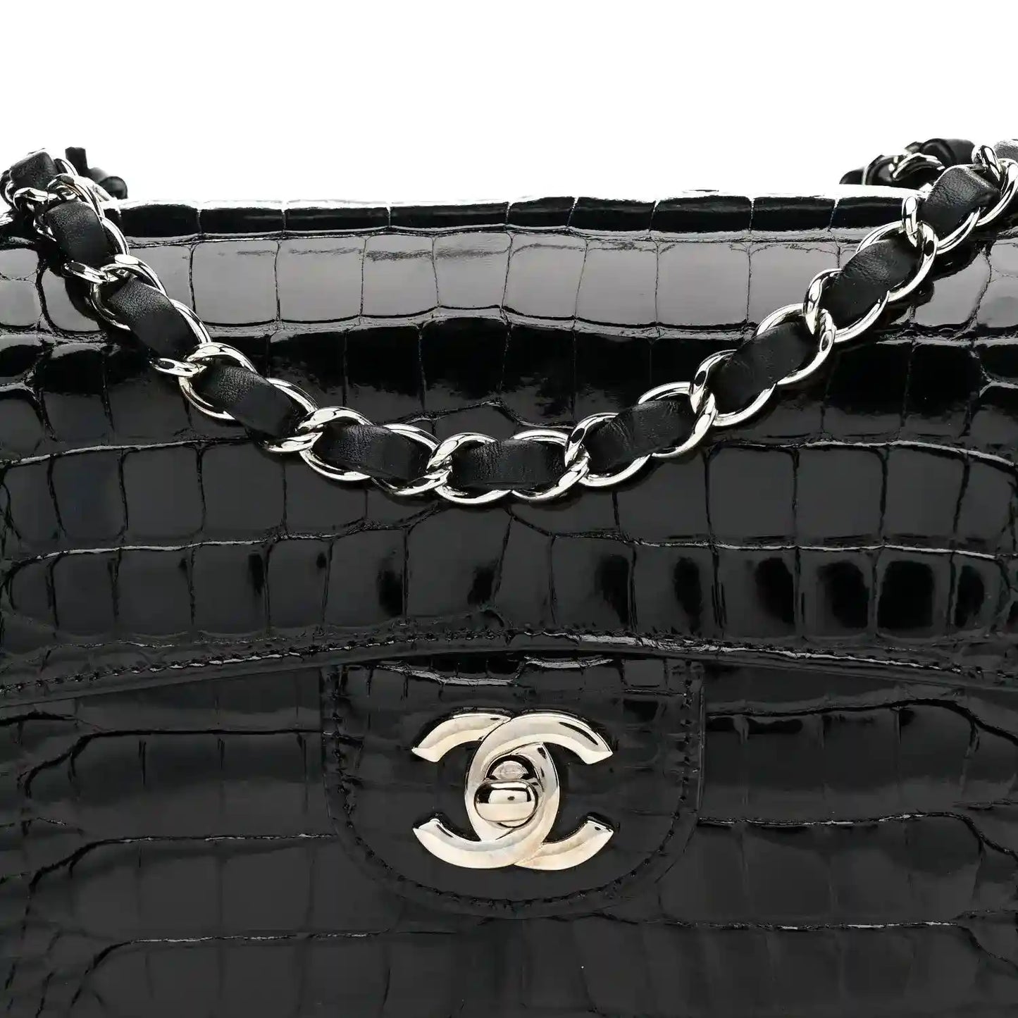 Black shiny alligator flap bag with Chanel turn-lock emblem and linked chain strap.