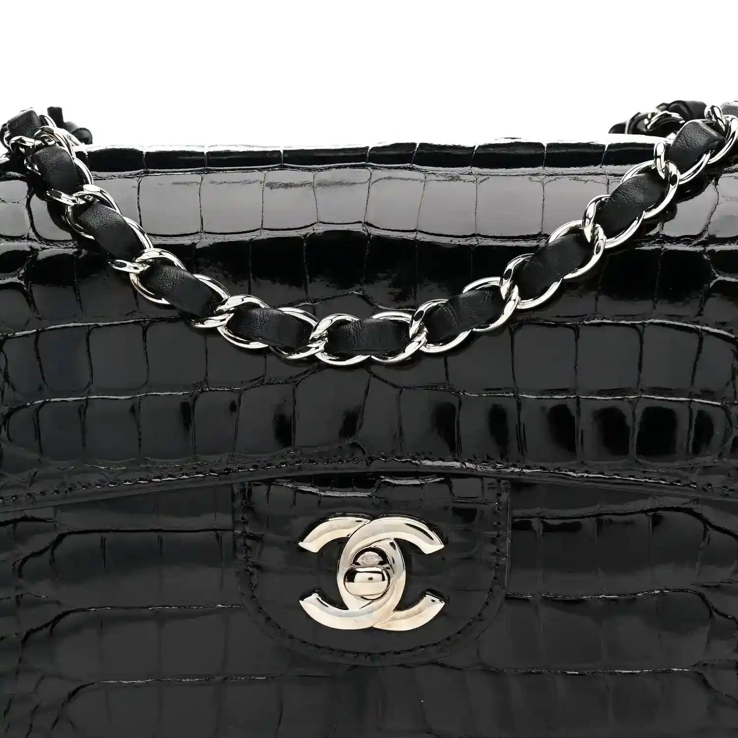 Black shiny alligator flap bag with Chanel turn-lock emblem and linked chain strap.