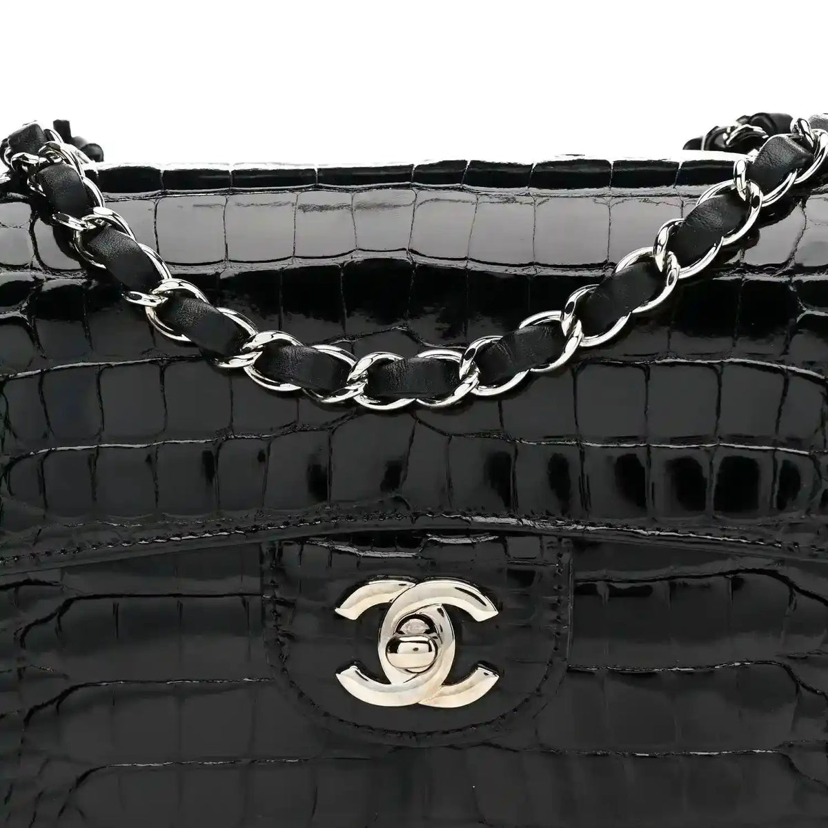 Black shiny alligator flap bag with Chanel turn-lock emblem and linked chain strap.