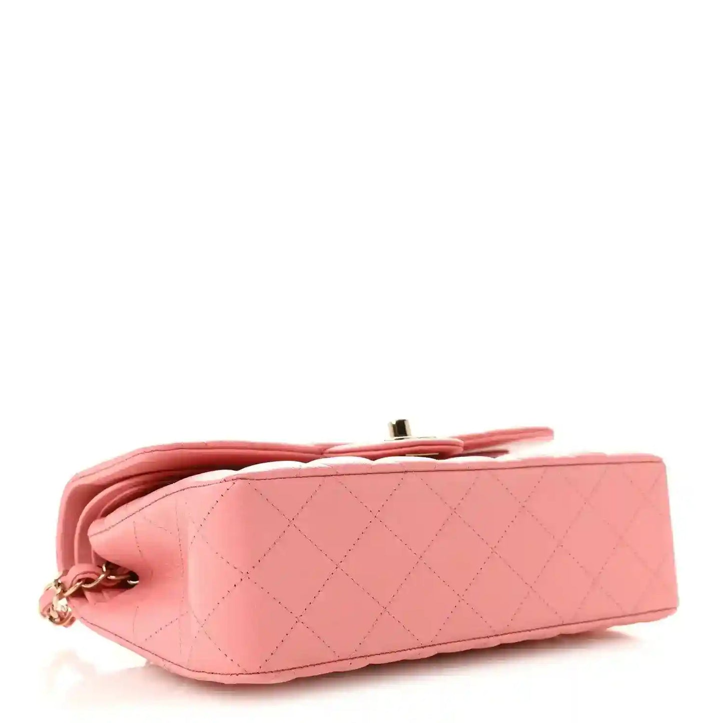 Light pink quilted bag with gold top hardware and curved flap profile