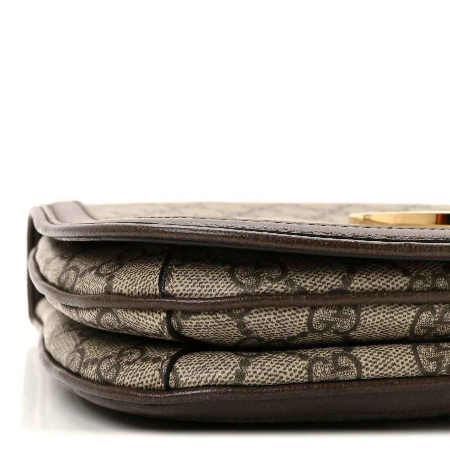 Stacked GG monogram canvas layers with brown leather trim and stitched flap edge