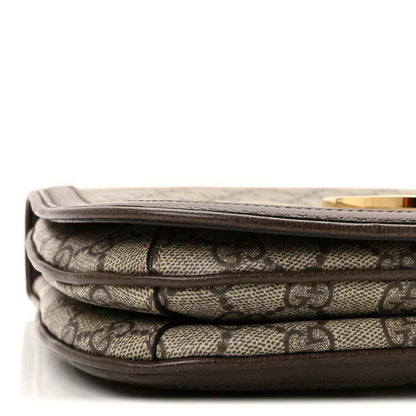 Stacked GG monogram canvas layers with brown leather trim and stitched flap edge