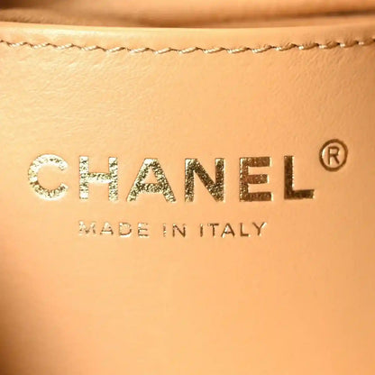Chanel leather label reading CHANEL and Made in Italy on classic beige suede