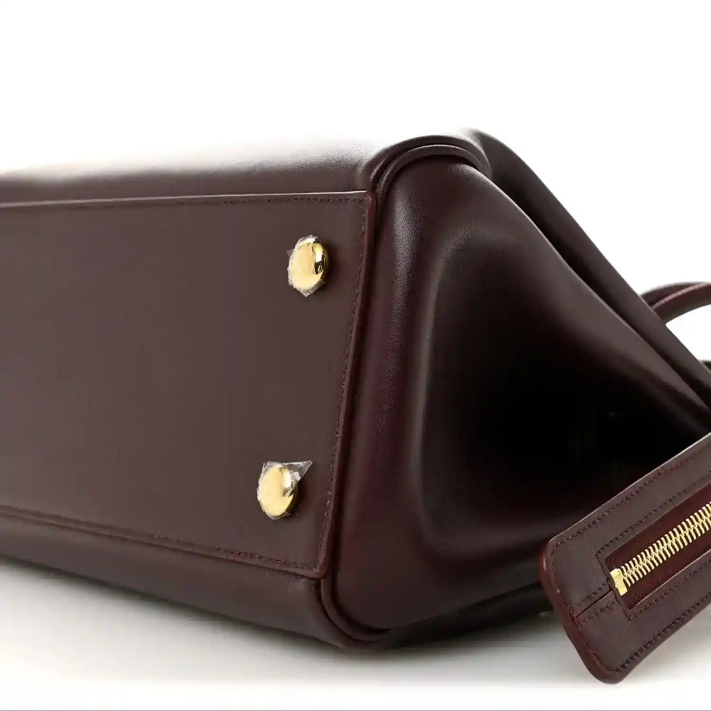 Loewe Small Madrid bag corner close-up in dark burgundy calfskin with strap and zipper