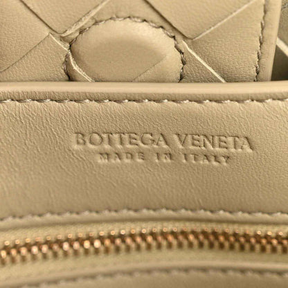 Bottega Veneta logo and zipper detail on travertine-tone leather interior