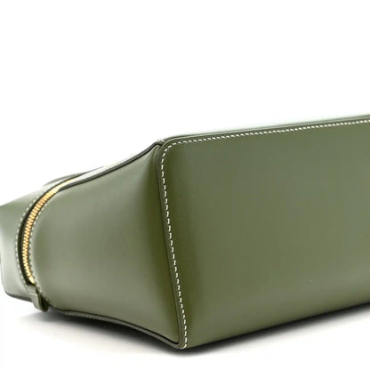 Olive green leather handbag side panel with curved seam and contrast edge stitching