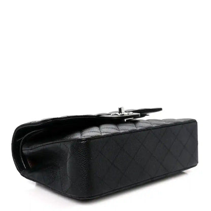 Black caviar-quilted leather flap bag with top handle and turn-lock clasp