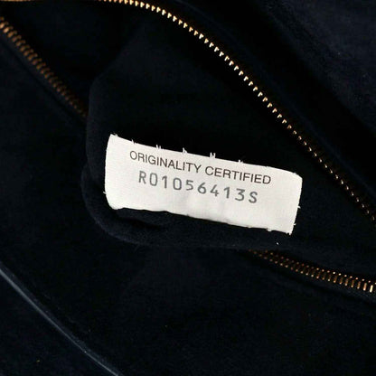 Black handbag with authenticity label reading ORIGINALITY CERTIFIED R01056413S