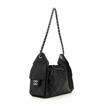 Black quilted mini shoulder bag with double flap pockets and chain shoulder strap.
