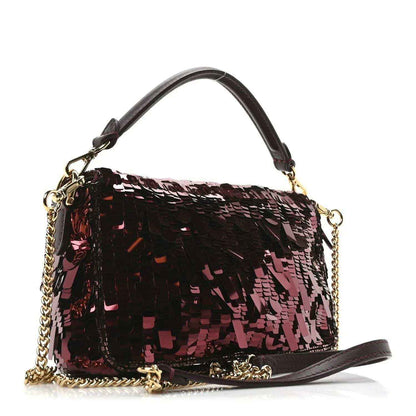 Mini baguette handbag with red and black sequin pattern, gold-toned chain strap, side view