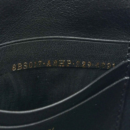 Black leather lining with embossed text, close-up on mini baguette bag.