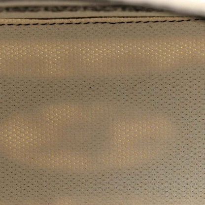 Christian Dior handbag lining texture close-up, tan woven fabric detail