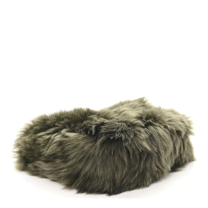 Dark olive shearling shoulder bag with long pile texture and slim black edge trim