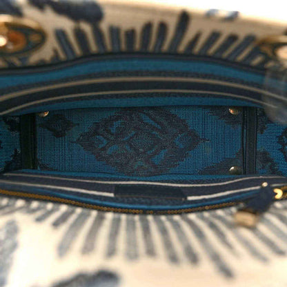 Bag top opening with blue patterned lining and navy trim along the edge