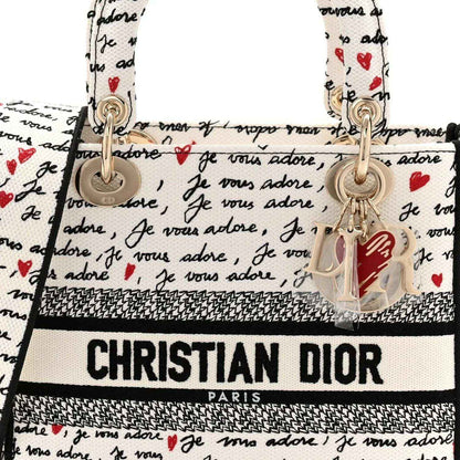Medium Lady D-Lite bag front with Dioramour print, top handles, and hanging charm