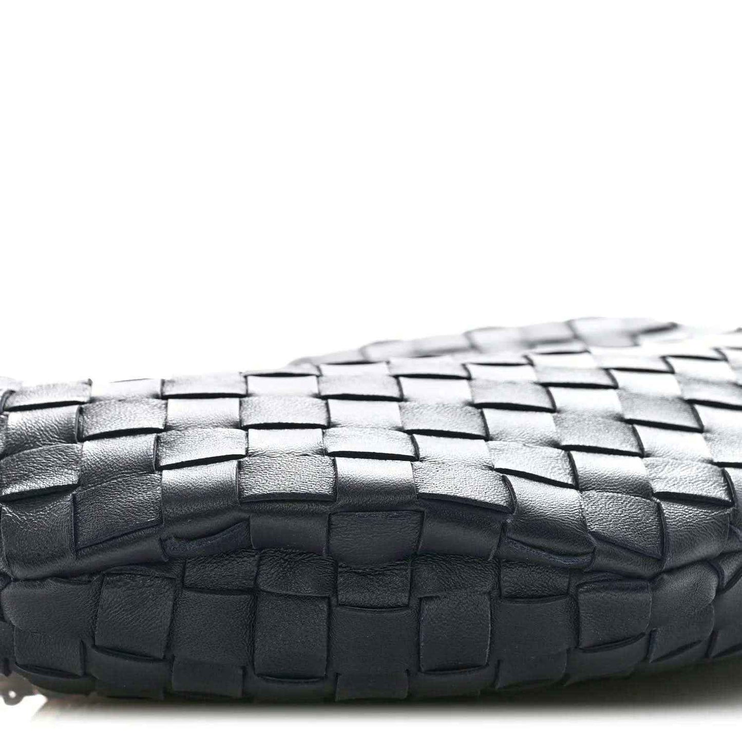 Close-up of black woven leather panel with a basket-weave pattern