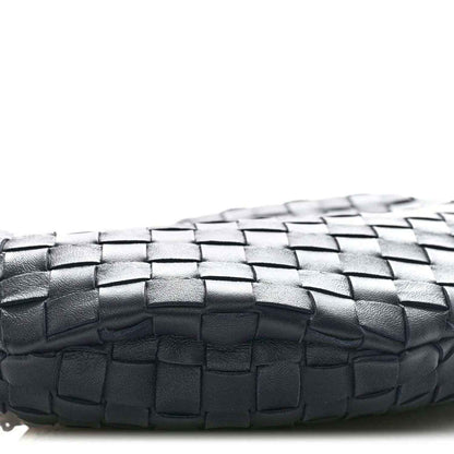 Close-up of black woven leather panel with a basket-weave pattern