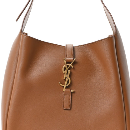 Tan hobo bag front with gold YSL logo and leather handle attachments