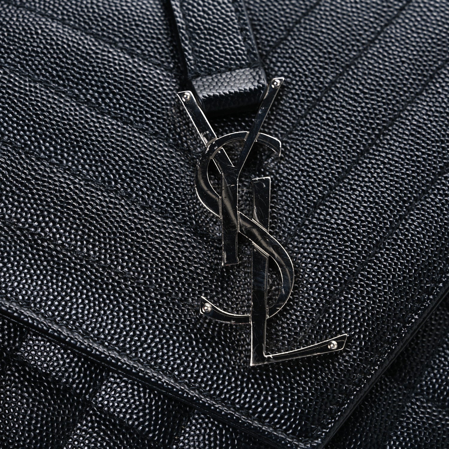 Black textured leather satchel front with metal YSL monogram hardware