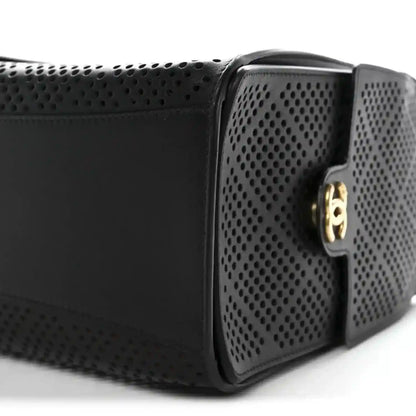 Chanel handbag with black perforated calfskin panels and gold clasp hardware