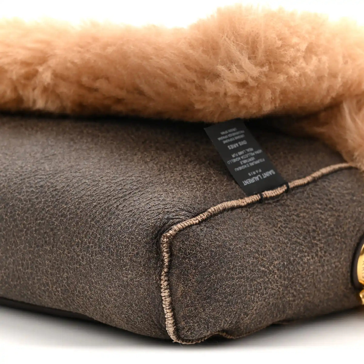 Saint Laurent reversible satchel interior label on dark leather with contrast edge stitching