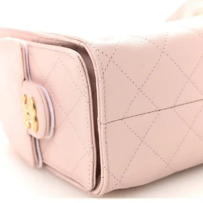 Light pink Chanel mini quilted leather handbag side profile with gold hardware