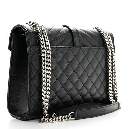 Black quilted medium satchel with chain strap and front flap, angled side view