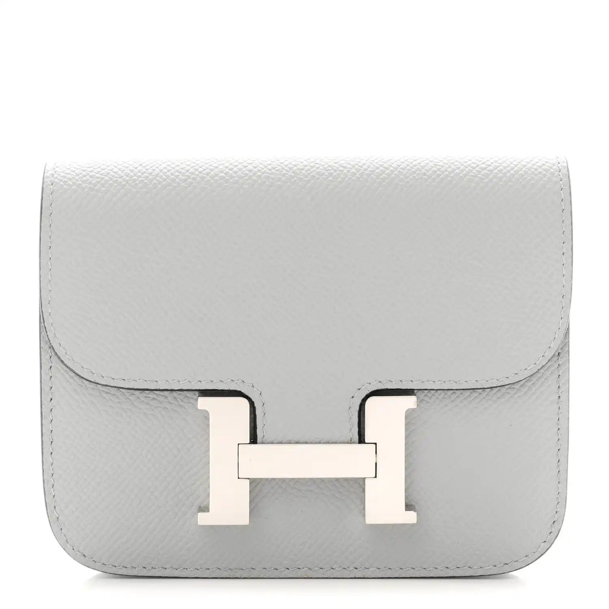 Hermes Constance slim wallet in light blue textured leather with front H clasp.