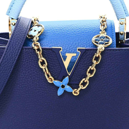 Blue handbag front with LV monogram panel and gold chain plus blue flower charm