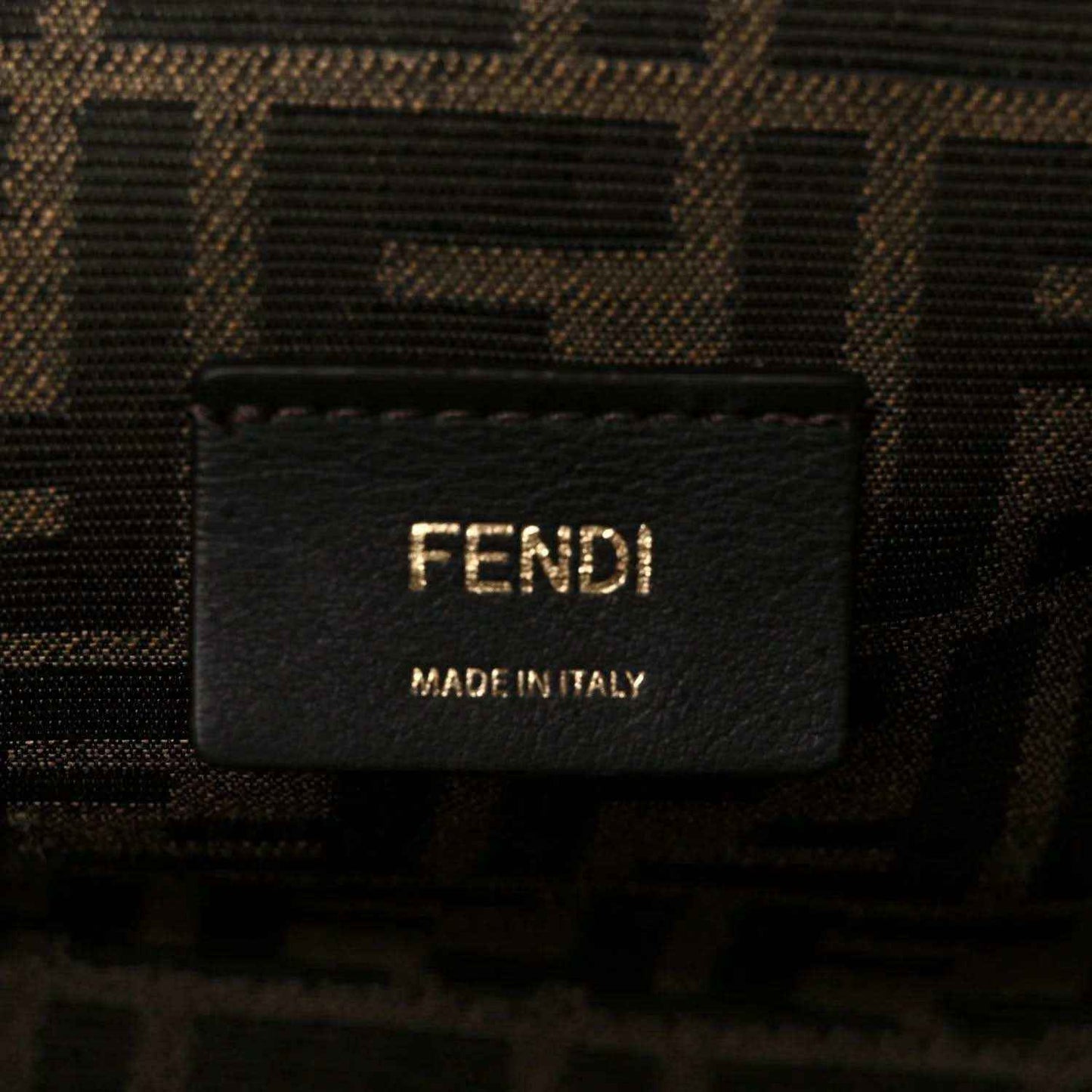 Fendi fabric label on interior of woven leather clutch bag