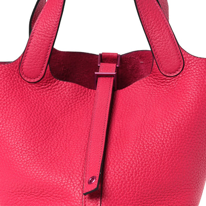 Rose pink textured leather bucket tote with front strap buckle