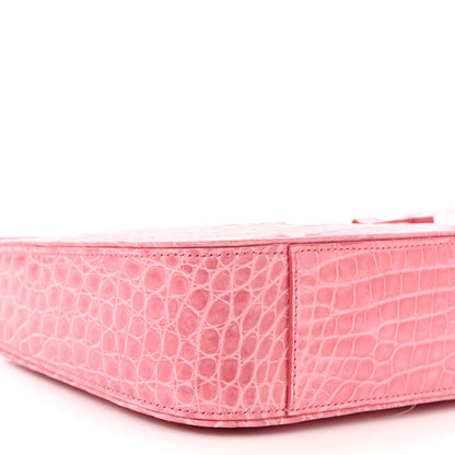 Pink alligator-textured hobo bag side profile with structured shape and top seam