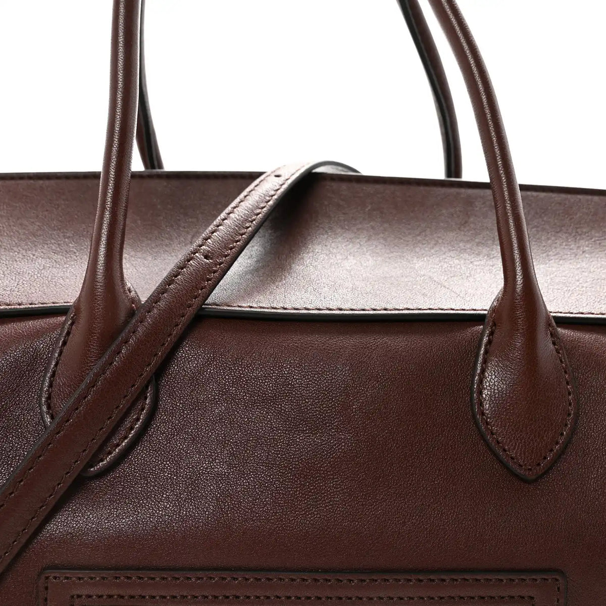 Leather handbag top handle bases with structured opening and stitched leather trim
