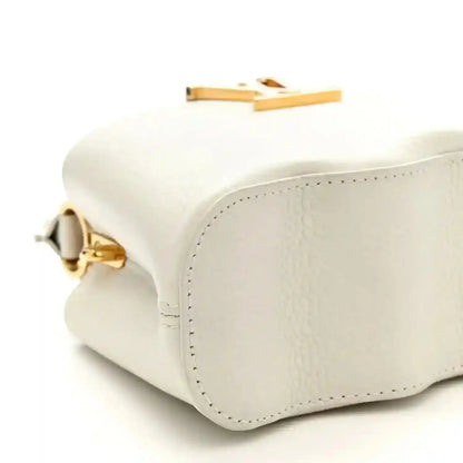 Louis Vuitton Capucines mini handbag, white, bottom corner with gold hinge detail