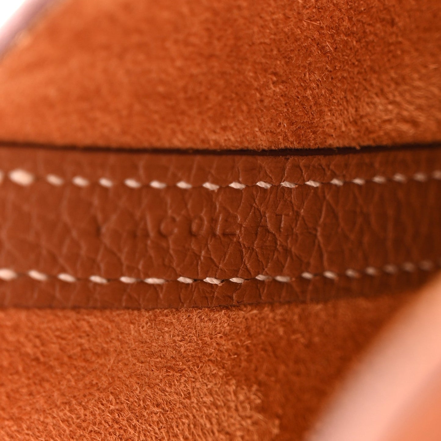 Close-up of cognac brown leather tote seam with contrast stitching